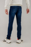 Jean azul intenso súper skinny con tiro bajo y desgastes de color