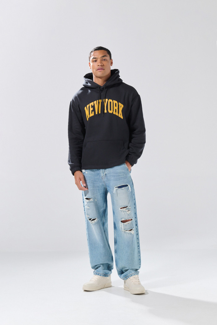 Buzo negro con capota oversize y texto college en frente
