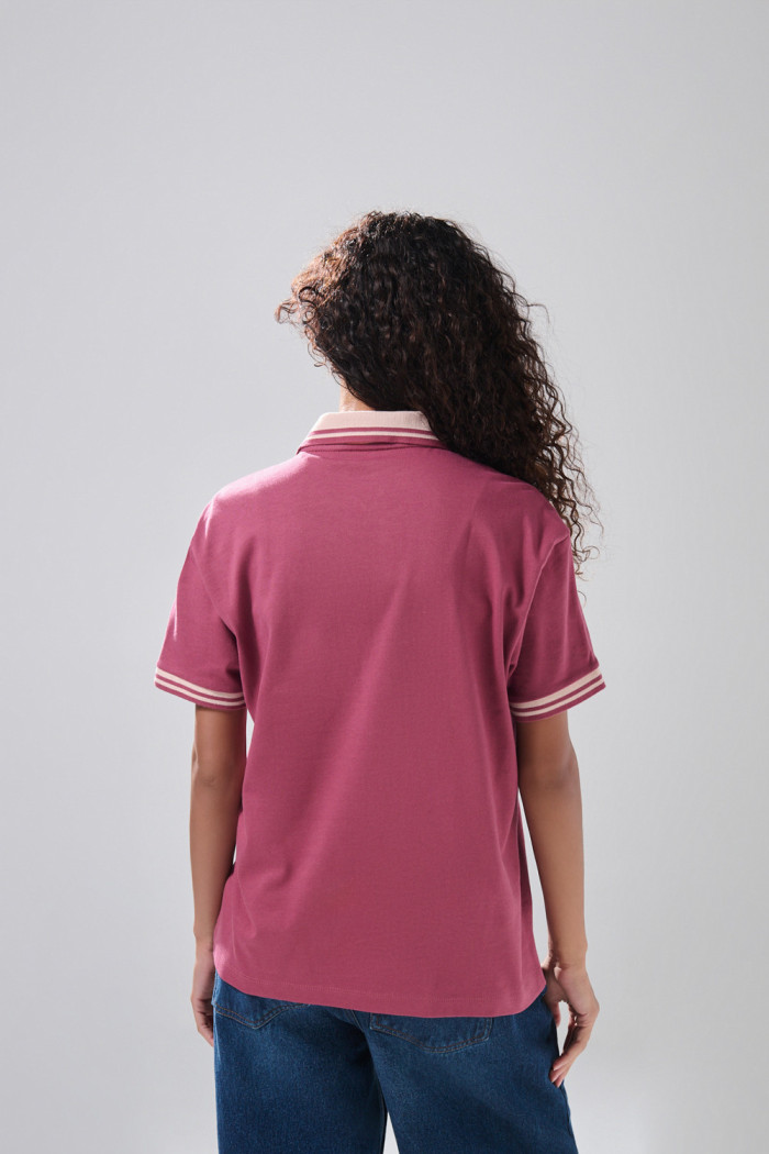 Camiseta cuello polo rosada con diseño college
