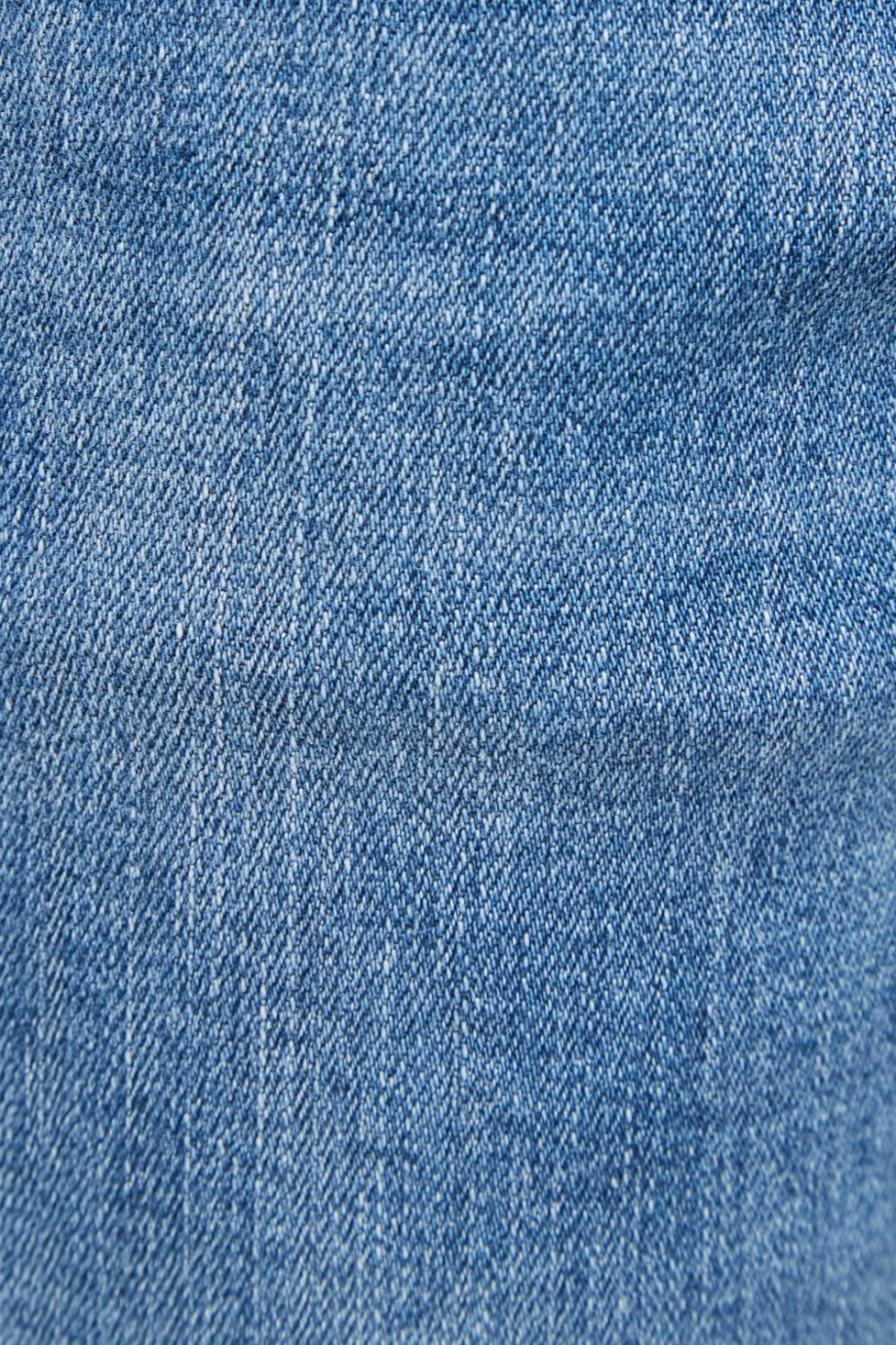 Jean súper skinny azul medio con desgastes de color y tiro bajo