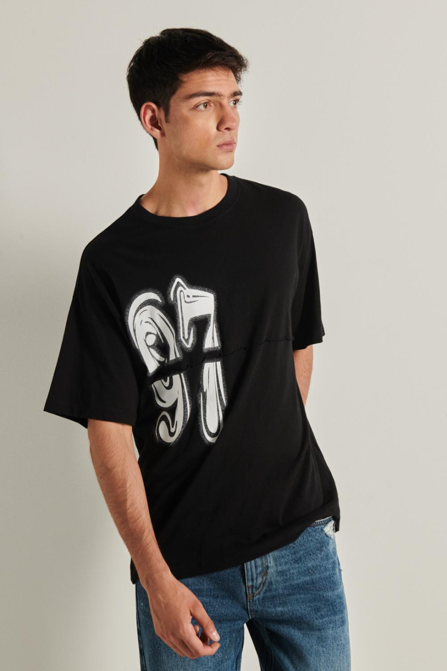 Camiseta negra oversize con manga corta y diseño en frente