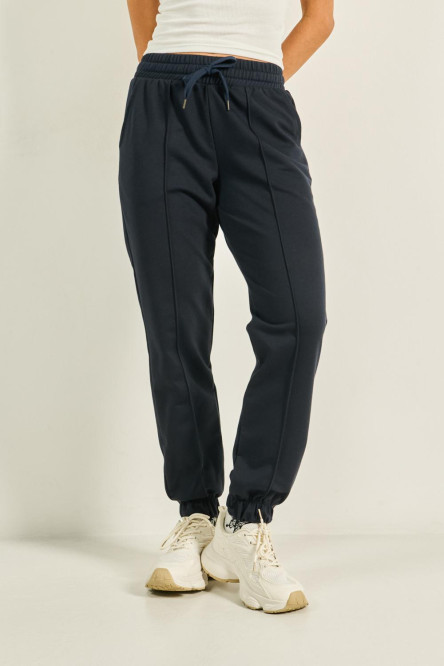 Pantalón unicolor jogger con vena decorativa y bolsillos