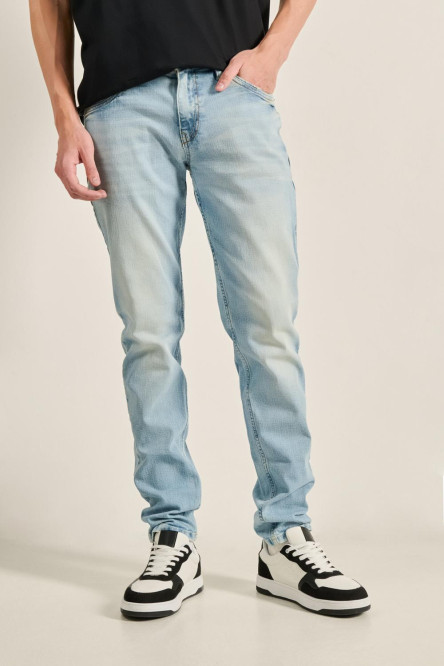 Jean azul claro skinny ajustado con desgastes y tiro bajo