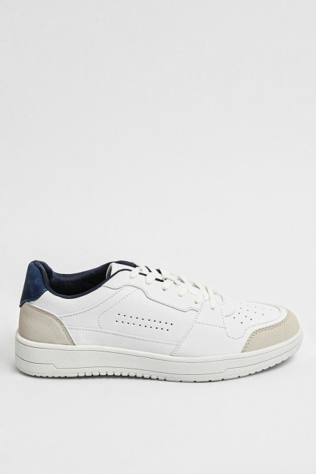 Tenis planos unicolores con perforaciones y contrastes