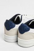 Tenis planos unicolores con perforaciones y contrastes