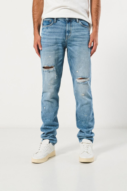 Jean slim azul tiro bajo con rotos y diseños de salpicaduras