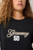 Buzo crop top negro con arte college y cuello redondo