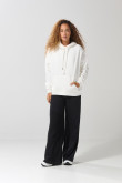 Buzo oversize perchado crema con capota y bolsillo