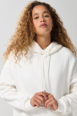 Buzo oversize perchado crema con capota y bolsillo