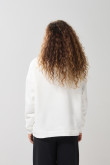 Buzo oversize perchado crema con capota y bolsillo