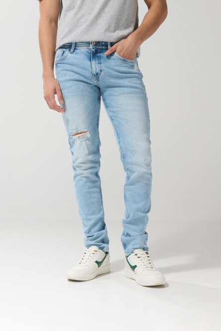 Jean azul claro skinny con desgastes localizados y tiro bajo
