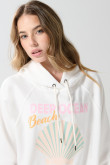 Buzo crema oversize con capota y diseño de playa
