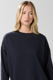 Buzo cuello redondo oversize unicolor con manga larga