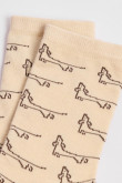 Medias kakis claras largas con diseños de perritos
