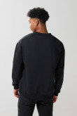 Buzo cuello redondo unicolor oversize con arte college