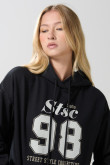 Buzo unicolor oversize college con capota y bolsillo