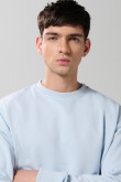 Buzo cuello redondo unicolor oversize con manga larga