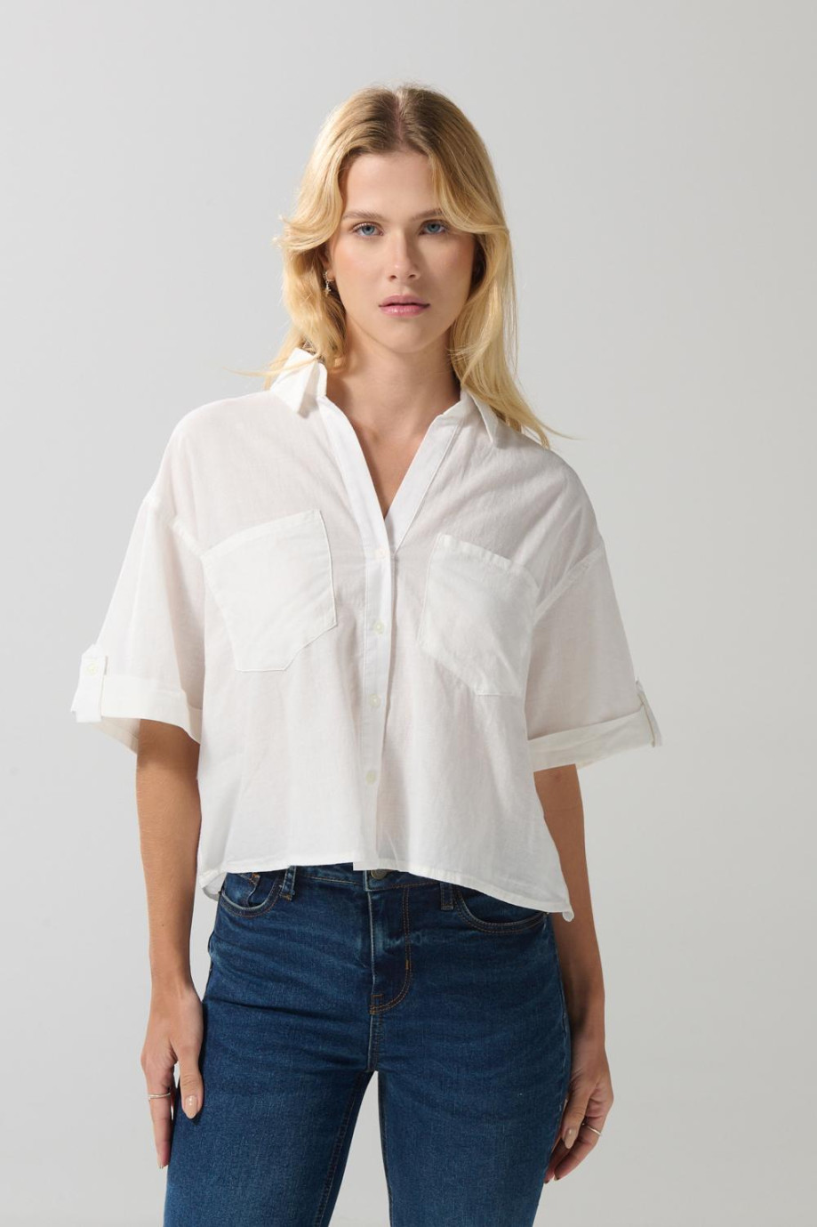 Blusa unicolor con botones, doble bolsillo y manga corta