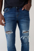 Jean skinny tiro bajo azul con desgastes y rotos