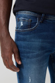 Jean skinny tiro bajo azul con desgastes y rotos