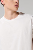 Camiseta cuello redondo unicolor con doblez en puños