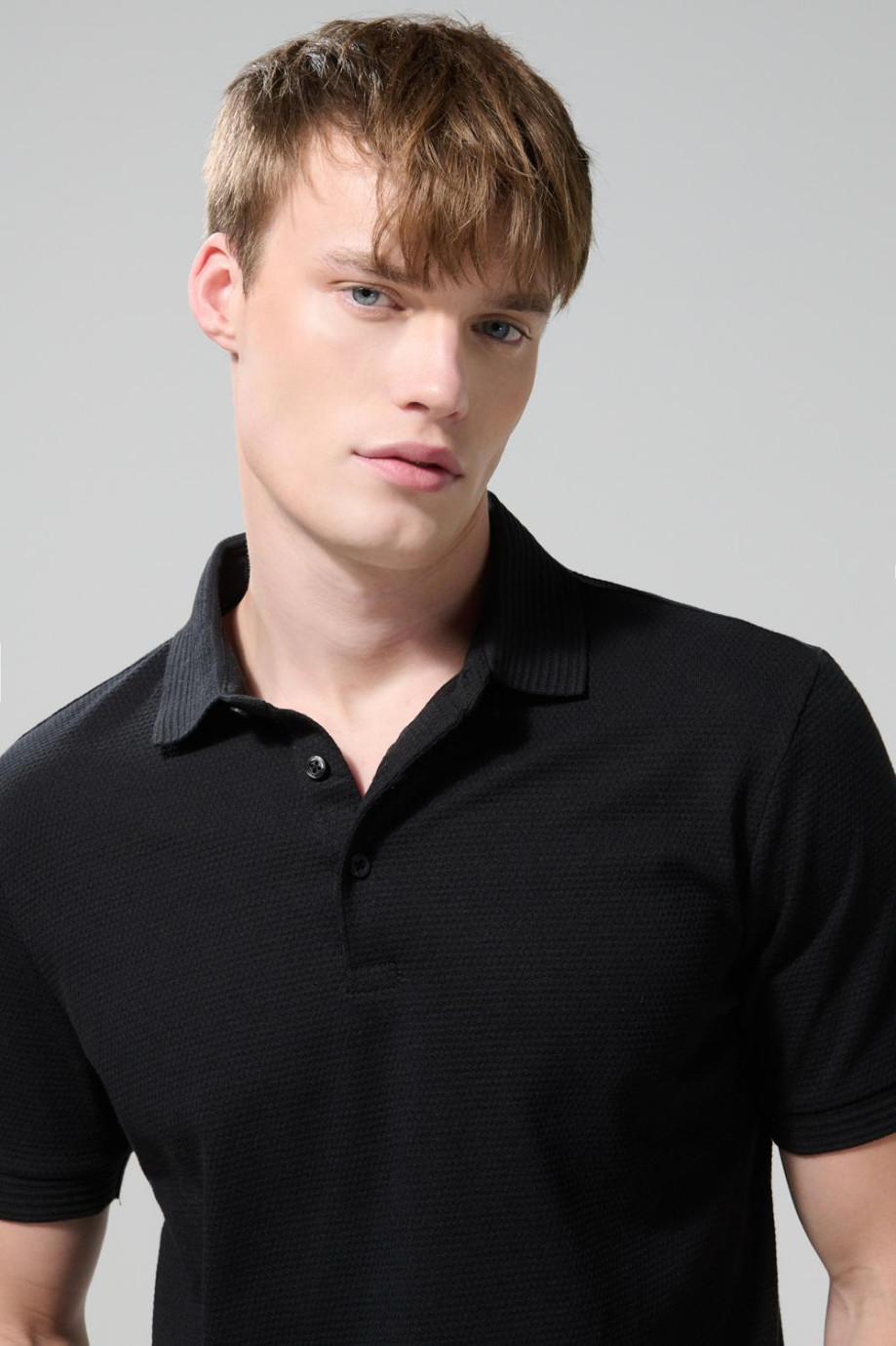 Camiseta unicolor tipo polo con manga corta y botones