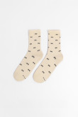 Medias largas crema con diseño de moños.