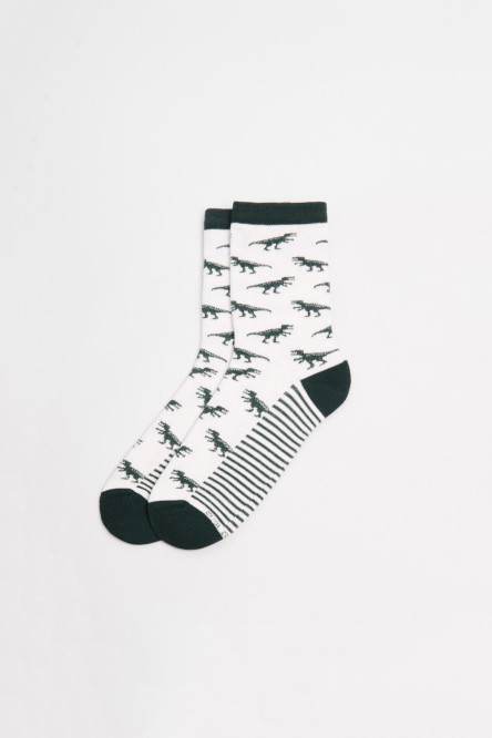 Medias unicolores largas con diseños de dinosaurios.