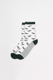 Medias unicolores largas con diseños de dinosaurios.