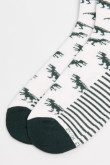 Medias unicolores largas con diseños de dinosaurios.
