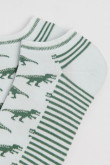 Medias tobilleras unicolores con artes de dinosaurios