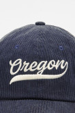 Gorra de beisbolera color kaki y azul con bordado 3D.