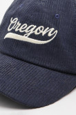 Gorra de beisbolera color kaki y azul con bordado 3D.