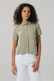 Blusa unicolor con cuello camisero y bolsillo en frente