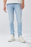 Jean skinny tiro bajo azul con desgastes y cremallera