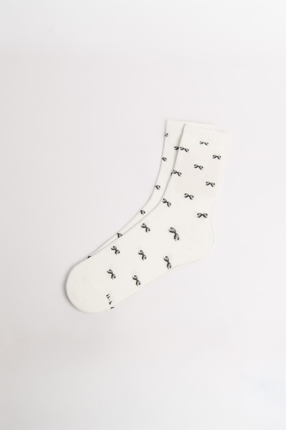 Medias unicolores largas con diseños de moños