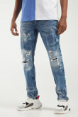 Jean skinny azul medio con rotos, parches y detalles en láser
